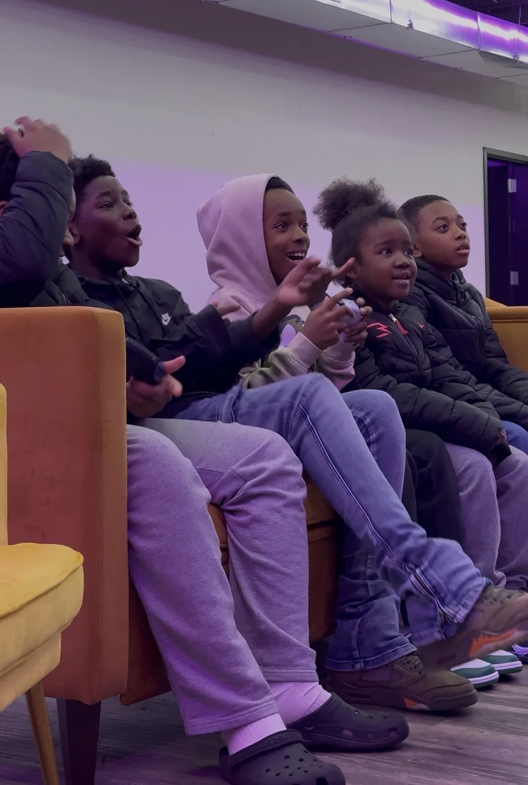 Students cheering on the console couches