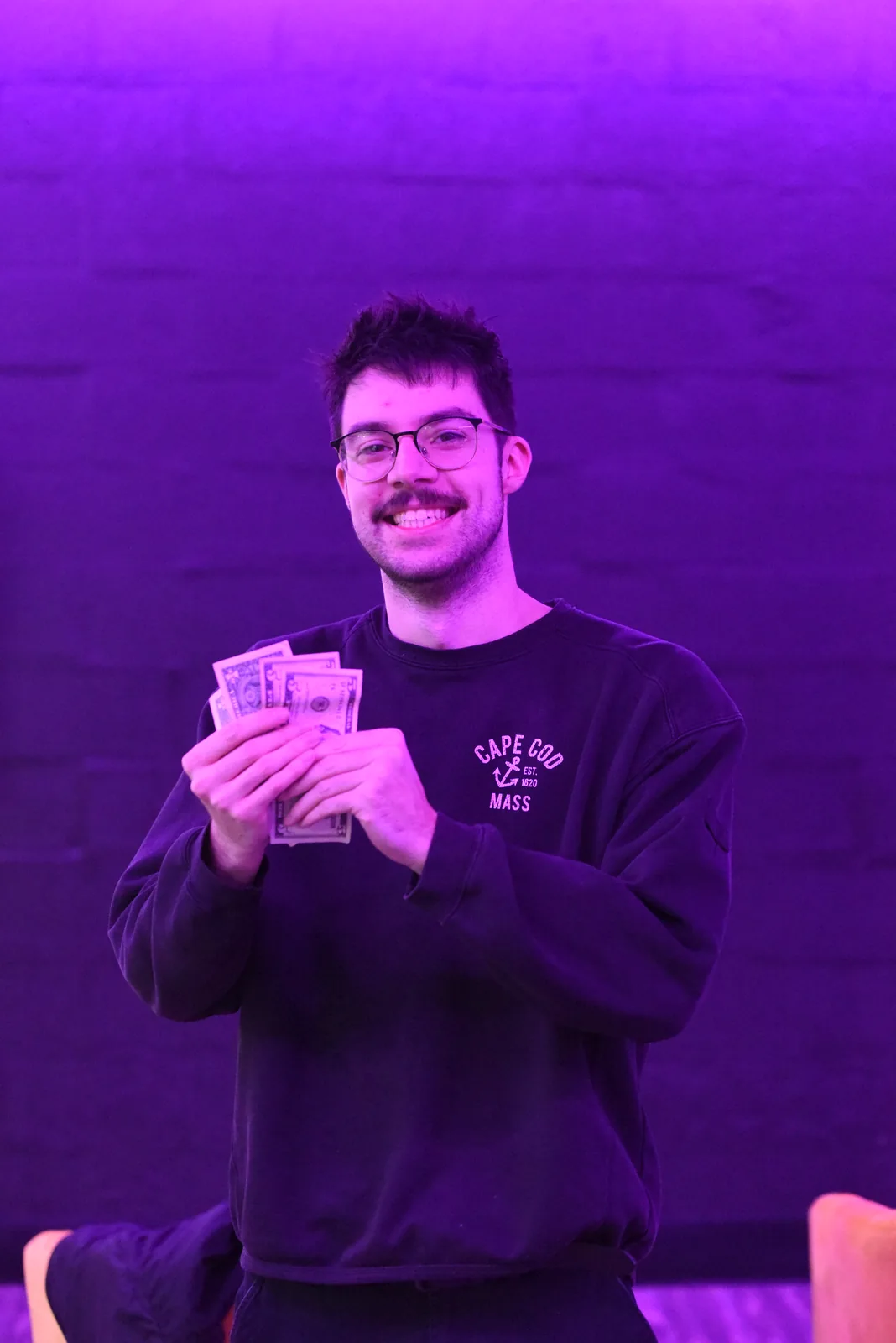 Tournament winner holding cash prize