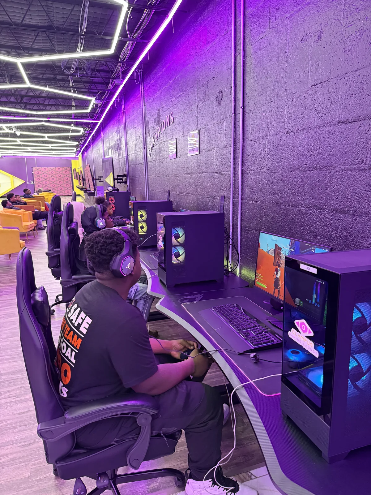 Player wearing a headset at an Olympus PC station