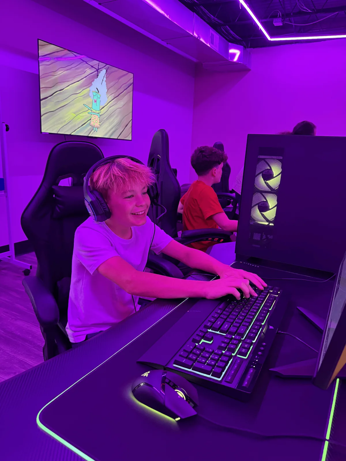 Young guest laughing at a gaming PC